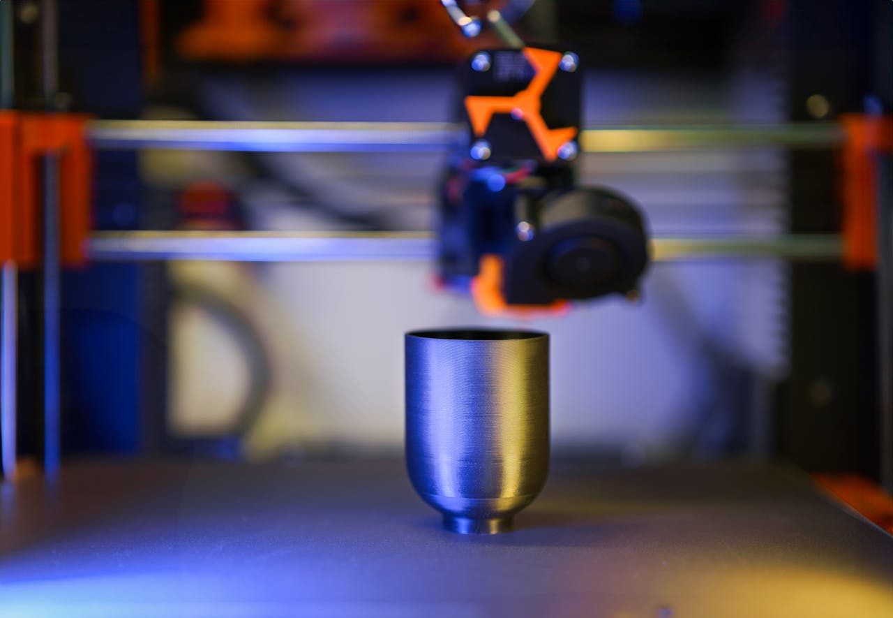 gallery-01 Innovative close-up of 3D printer crafting a metallic object, showcasing modern technology.